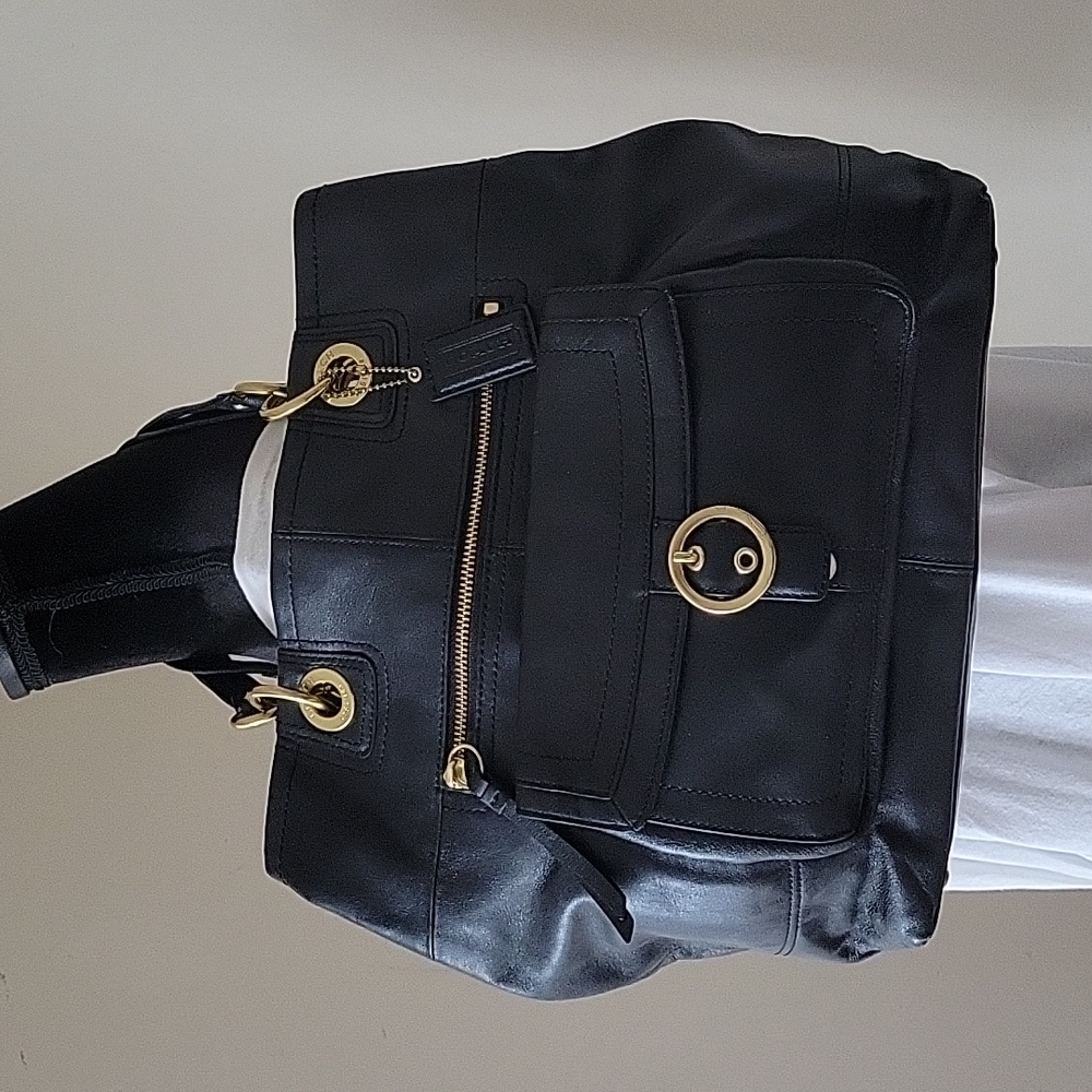 Black w/ gold tone accent leather shoulder bag. Excellent condition.